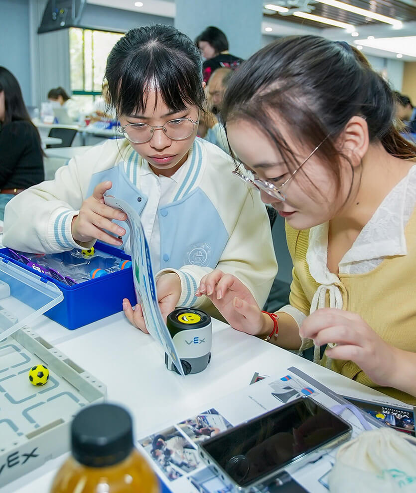A robotics team of young women posing for a photo at a Girl Powered event.